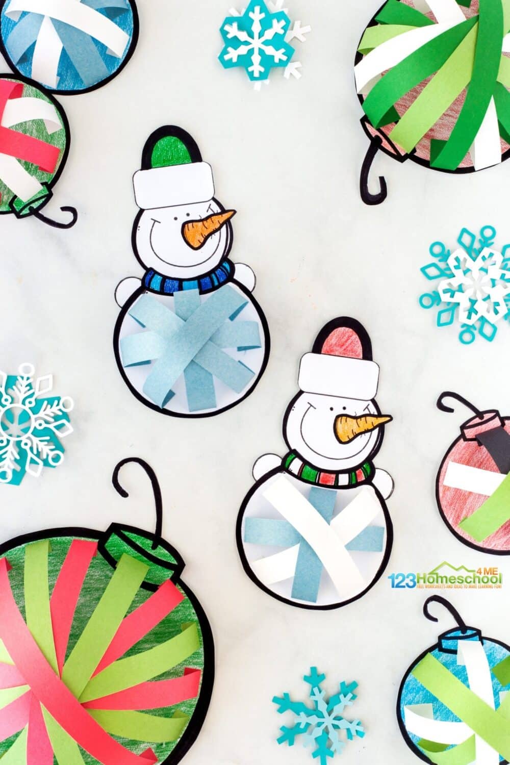 A photo of cute printable preschool ornament crafts featuring paper snowmen and Christmas baubles with three-dimensional details made out of colored paper.