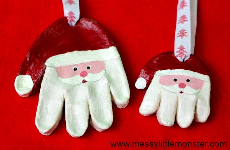 A photo of a cute salt dough Santa ornament idea for preschoolers using their handprints.
