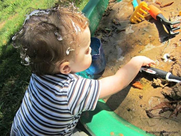 Getting More Mud for a Kids Mud Pie at a Messy Playdate at B-InspiredMama.com