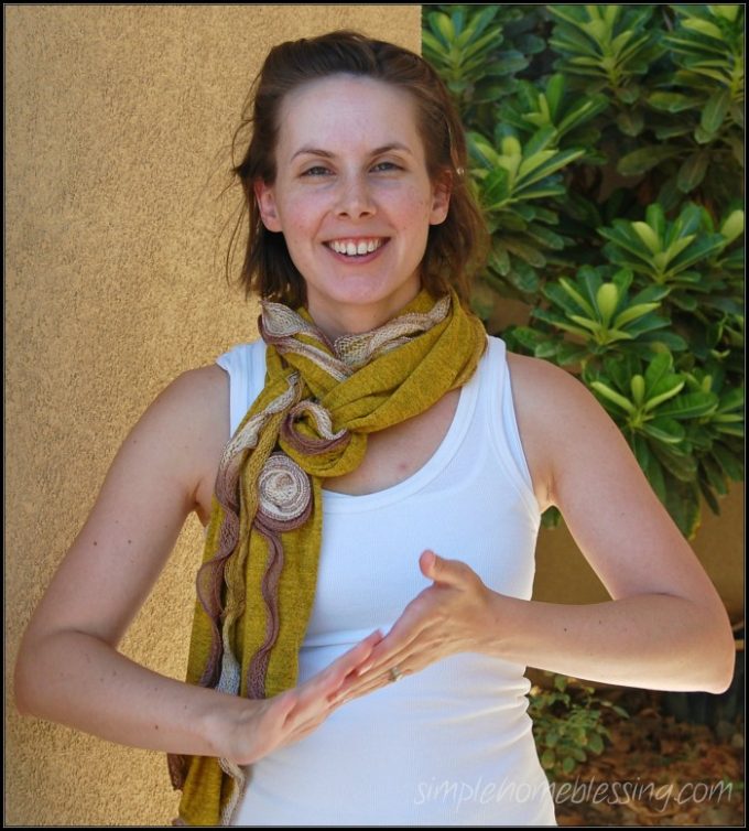 A photo of a mother demonstrating "All Done" in Sign Language.