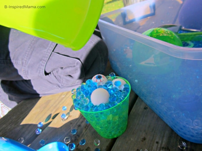 Scooping and Pouring During Our Monster Eyes Sensory Play at B-Inspired Mama