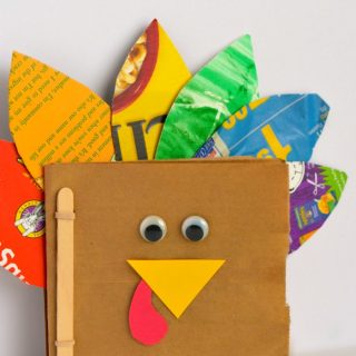 A photo of a Thankful Turkey Book Craft made out of brown paper bags by a preschooler for Thanksgiving.