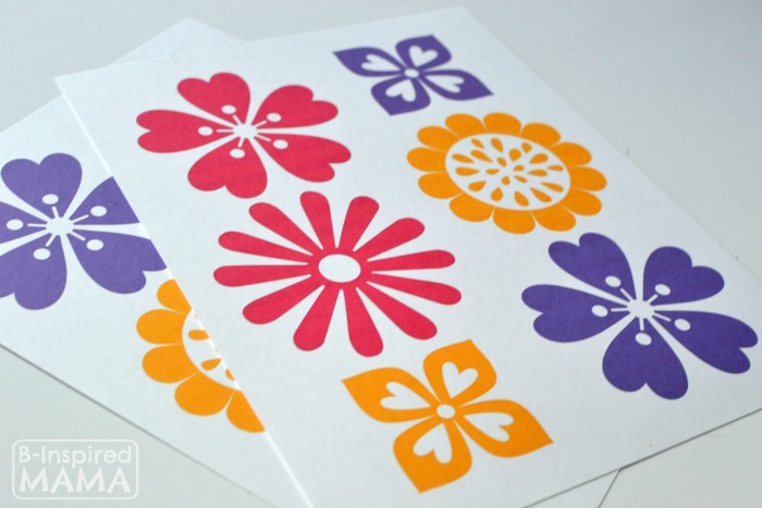 A photo of a free Mother's Day craft printable featuring stylized orange, pink, and purple flowers to use for making a DIY craft bowl.