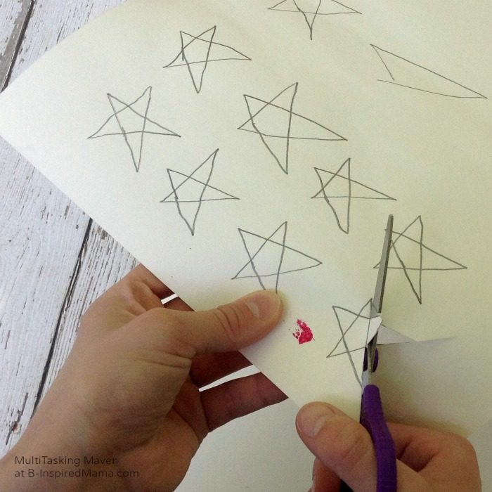 An Ice Paint American Flag Craft - Cutting Out Stars - B-Inspired Mama