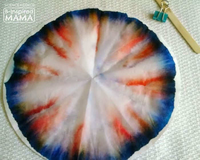 A photo of a colorful dyed coffee filter made during a Marker Chromatography Experiment for kids. 