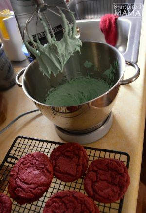 Easy Red Velvet Christmas Cookie Sandwiches - Mixing Green Frosting - at B-Inspired Mama