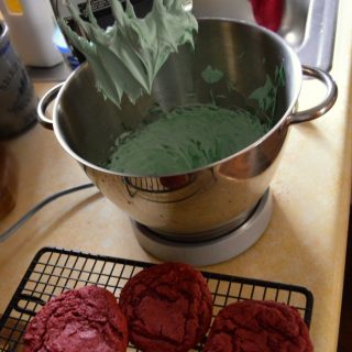 Easy Red Velvet Christmas Cookie Sandwiches - Mixing Green Frosting - at B-Inspired Mama