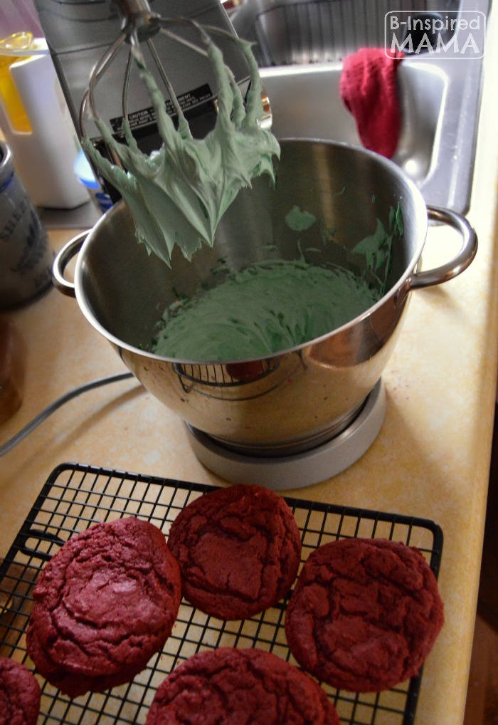 Easy Red Velvet Cake Mix Cookies for making festive Christmas Cookie Sandwiches - Mixing Green Frosting - at B-Inspired Mama