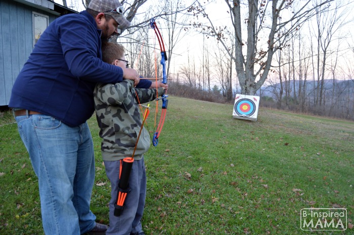 The Best Big Gifts for Kids - A 2015 Holiday Gift Guide - Cliff Helping Sawyer Shoot Bow - at B-Inspired Mama