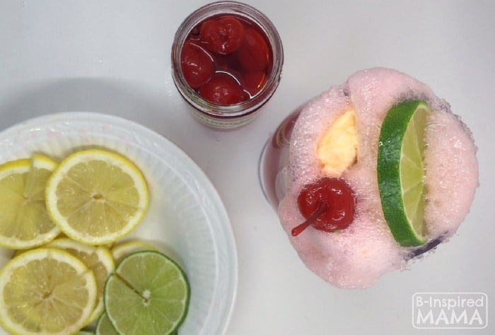Making Kid-Friendly Fizzy Party Punch for New Years Eve for Kids - Adding Lemons and Cherries - at B-Inspired Mama