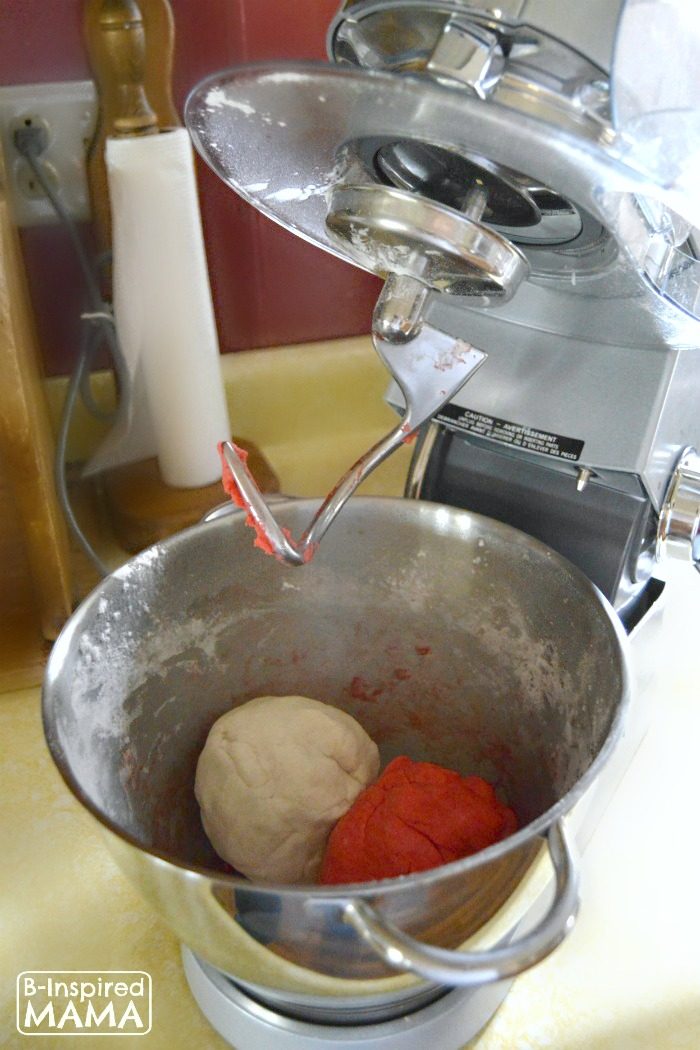 A photo of homemade Candy Cane Peppermint Playdough Recipe being made inside a kitchen stand mixer.