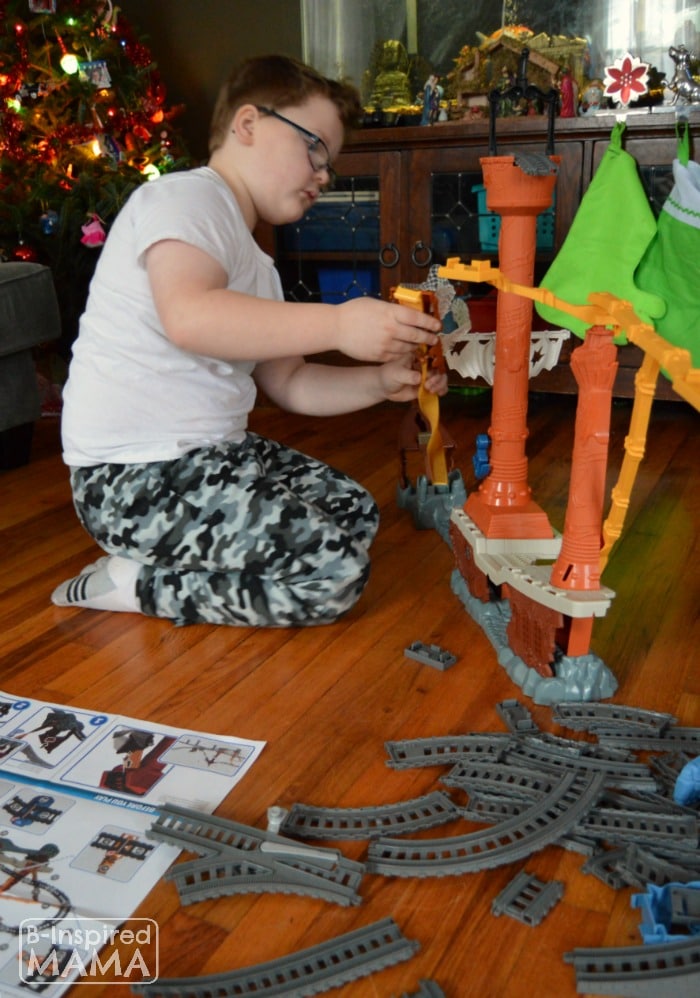 Sawyer Putting Together Our New Thomas Trackmaster Set + A Printable Train Ticket Holiday Gift Tag at B-Inspired Mama