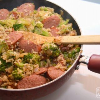 A photo of a frying pan full of a Smoked Sausage and Rice Skillet meal, including sliced Hillshire Farm Smoked Sausage, broccoli, and rice.