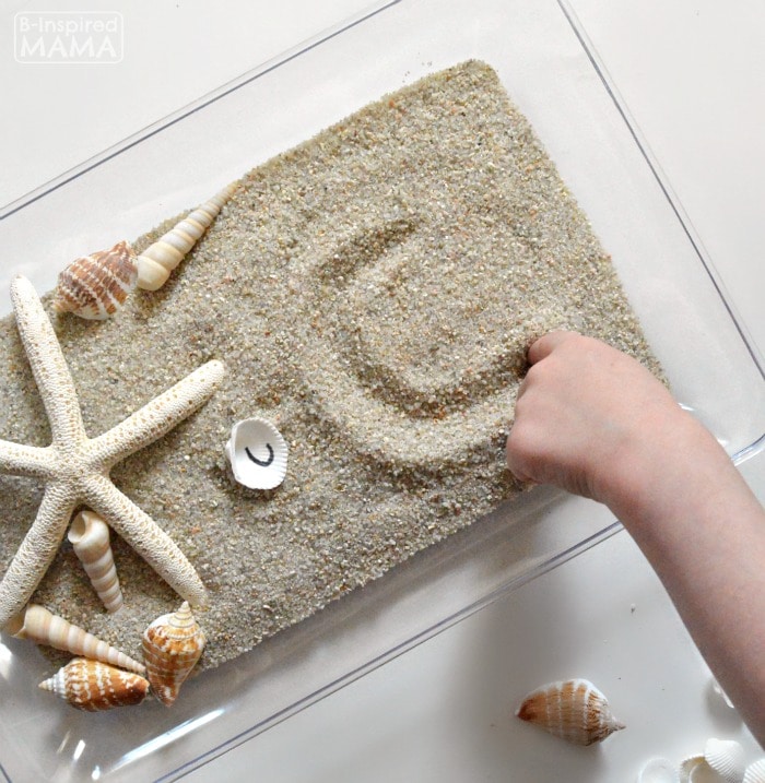 Learning the Alphabet with Seashells and Sand Sensory Writing - Practicing Handwriting Letters - at B-Inspired Mama