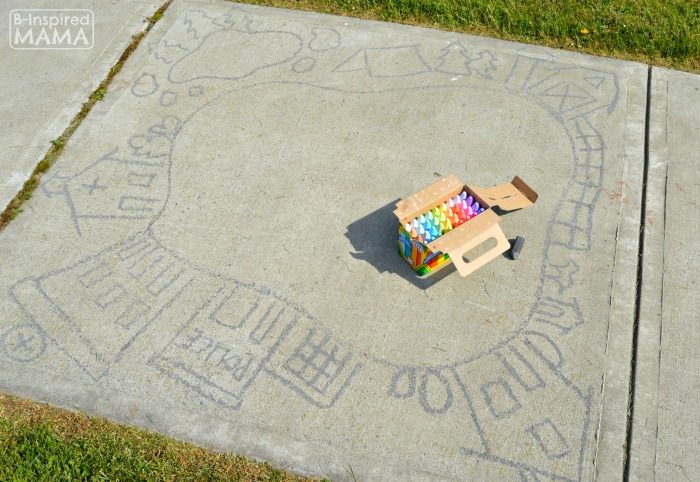 A photo of the outline drawn on a sidewalk for a sidewalk chalk art town and road, sidewalk chalk art for kids to play cars in.