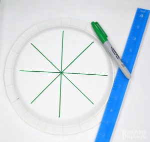 A photo of a paper plate with marks on it for a Crown 4th of July Craft for Preschoolers.