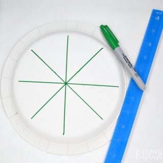 A photo of a paper plate with marks on it for a Crown 4th of July Craft for Preschoolers.