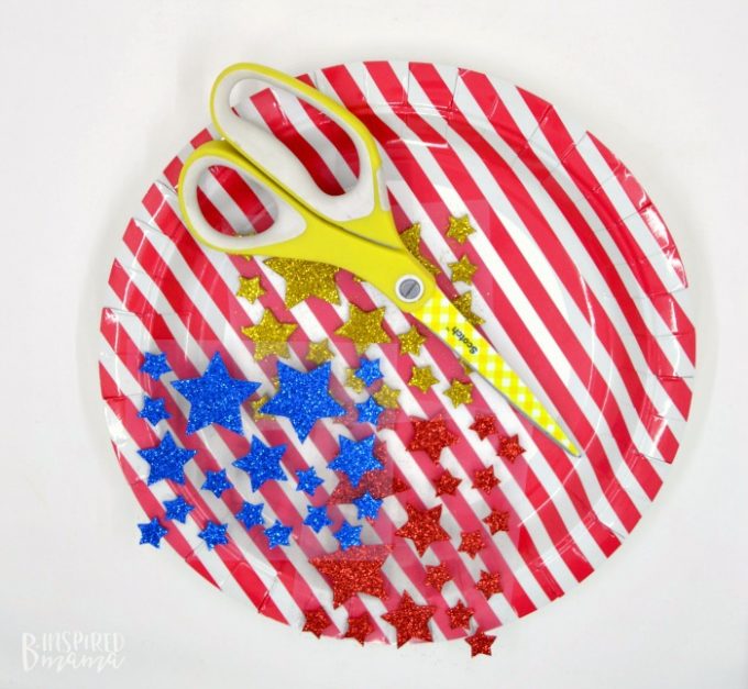 A photo of the supplies for a paper plate crown craft for 4th of July.
