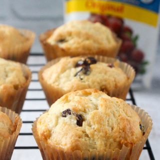 A photo of golden muffins made with a Cranberry Orange Muffins Recipe.