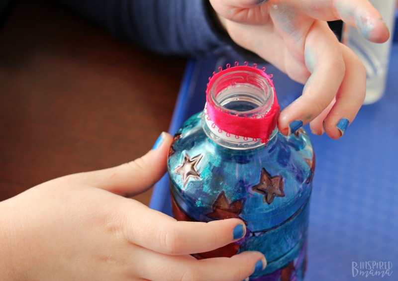 Adding ribbon to our Tum-E Yummies bottle for our Funky Flower Vase Plastic Bottle Craft