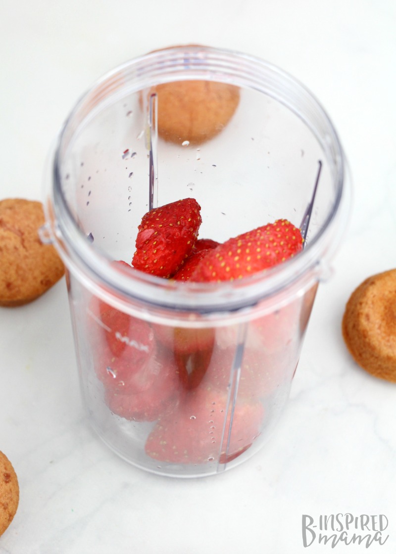 Adding strawberries for our Strawberry Yogurt Muffin Kids Smoothie - at B-Inspired Mama
