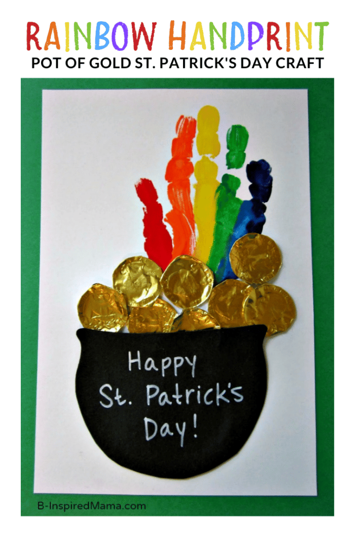 A photo of a Rainbow Pot of Gold St Patrick's Day Handprint Craft featuring a rainbow-painted handprint coming out of a pot of gold coins (made out of chocolate gold coin wrappers).