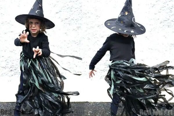 A photo of a young girl spinning around, dressed in a DIY witch costume for Halloween.
