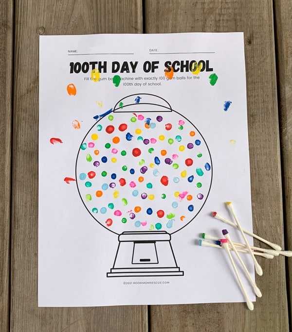 A photo of a free 100th day of school printable for a cute gumball machine-themed craft for kids.