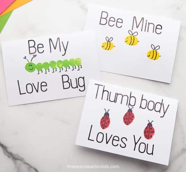 Three printable Valentines featuring kids fingerprints with details drawn on to make them look like bugs, including a caterpillar, bees, and ladybugs. Each card has an insect pun saying, including "Be my love bug," "Bee mine," and "Thumb body loves you." An easy non-candy Valentine idea for kids of all ages.