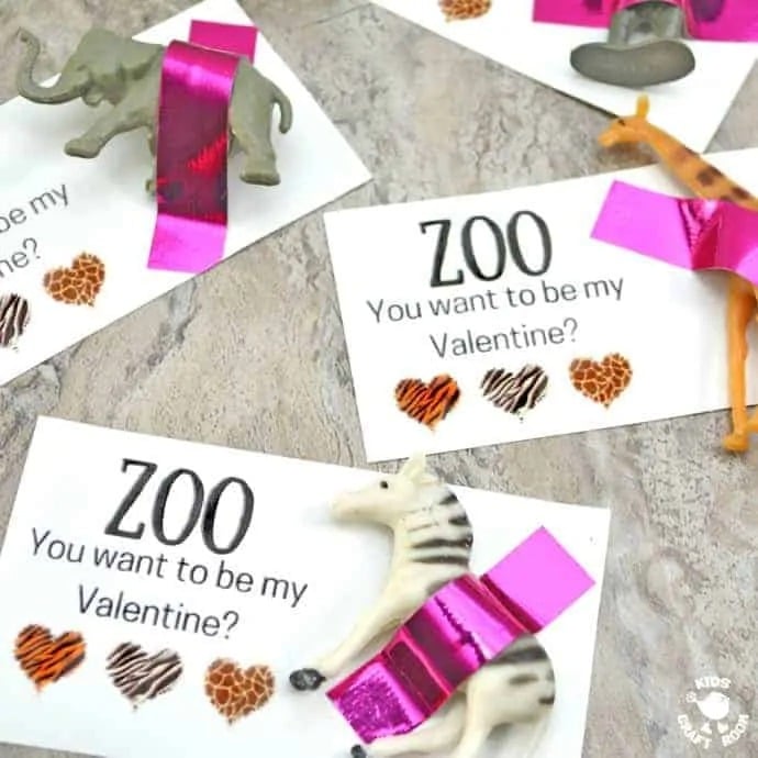 Several free printable wild animal themed Valentines with little plastic toy animals taped on using metallic washi tape. Cards read, "Zoo you want to be my Valentine?"