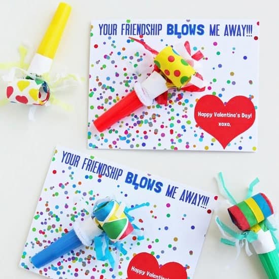 Two free printable Valentines with a colorful party blower tapes onto each and the saying "Your friendship blows me away!" An awesome non-candy Valentine idea for preschool classroom Valentine's Day party.
